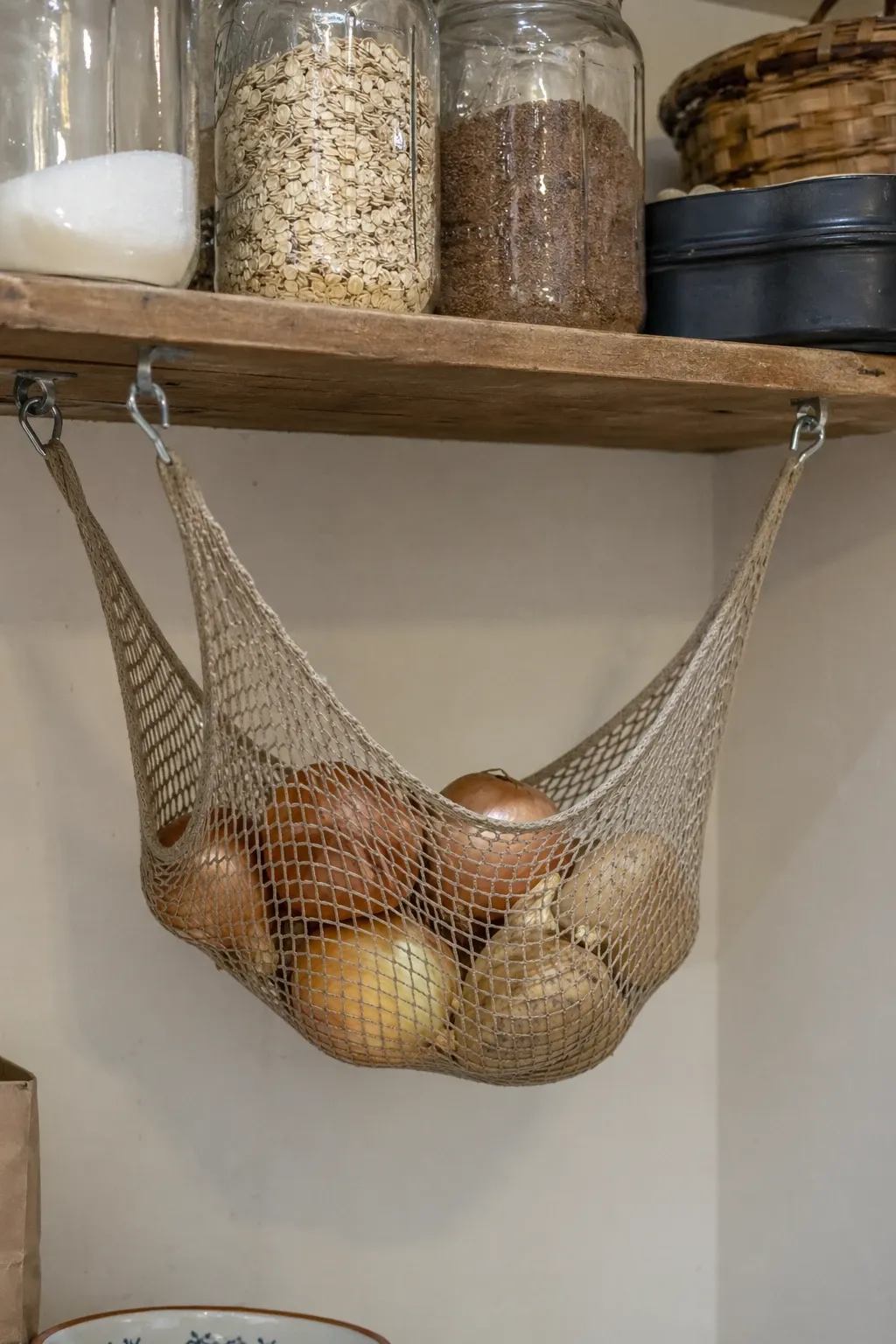 hanging fruit and vegetable hammock in a closet