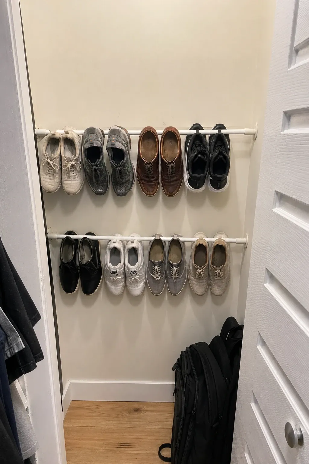 tension rod shoe rack in a entryway