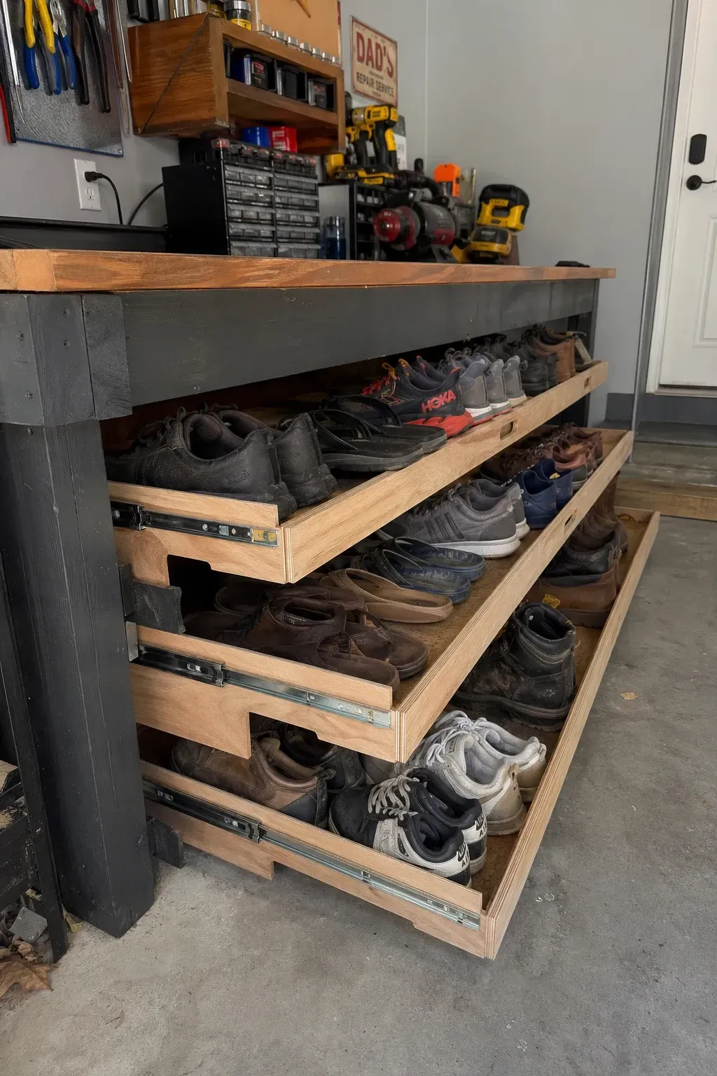 under-workbench slide-out trays in a garage
