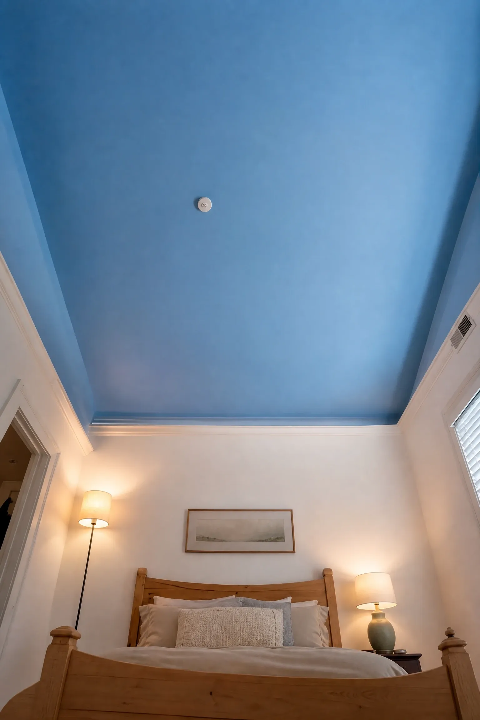 blue painted ceiling as an unexpected focal point in a bedroom