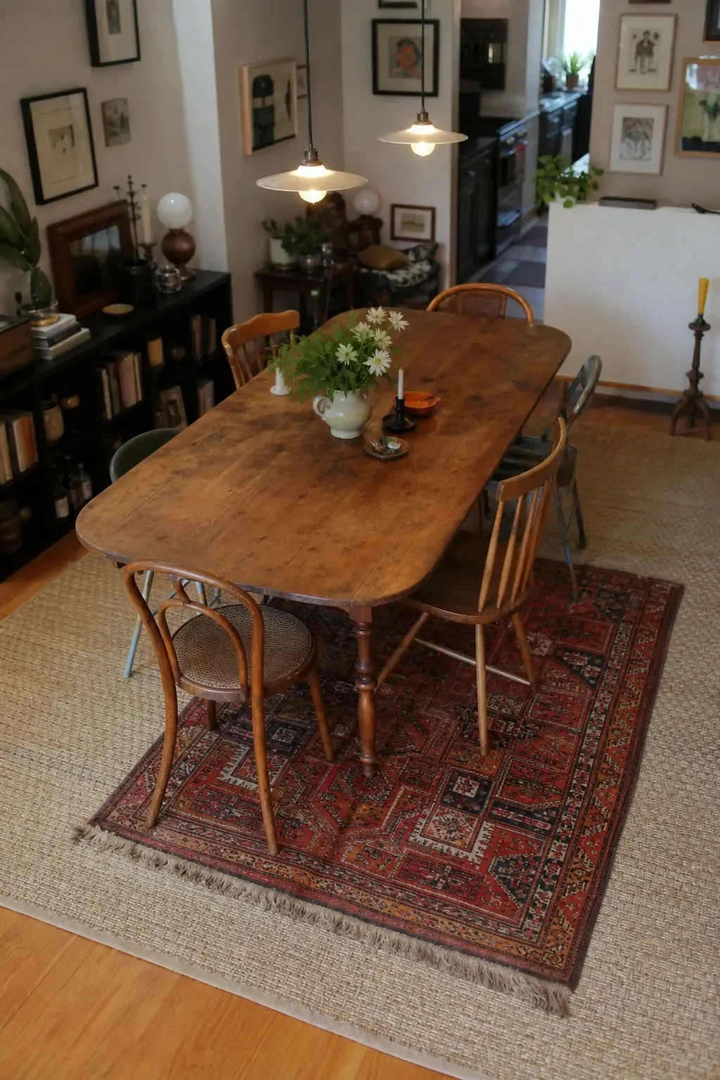 layered rugs: jute base with a vintage rug on top in a dining room