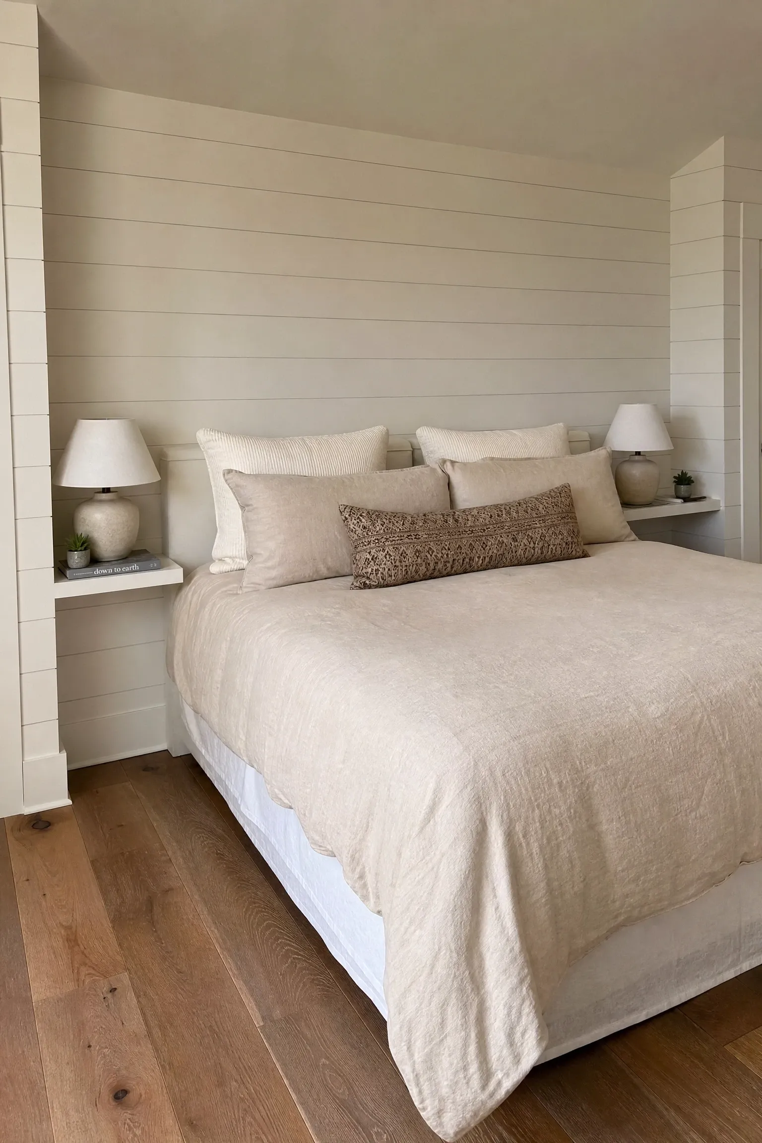 built-in shiplap shelving beside the bed in a bedroom