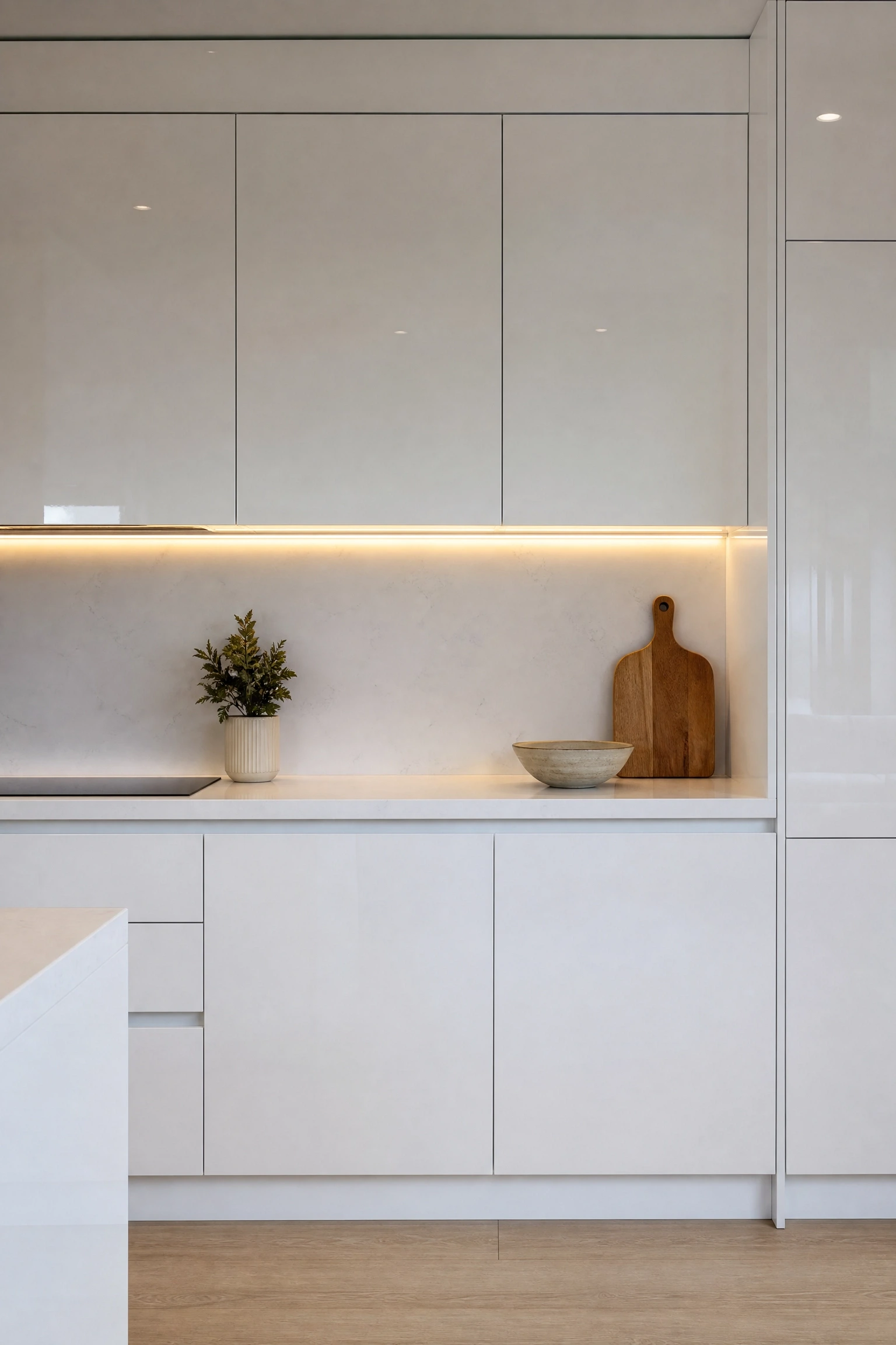 handleless acrylic cabinets with push-to-open mechanisms in a kitchen