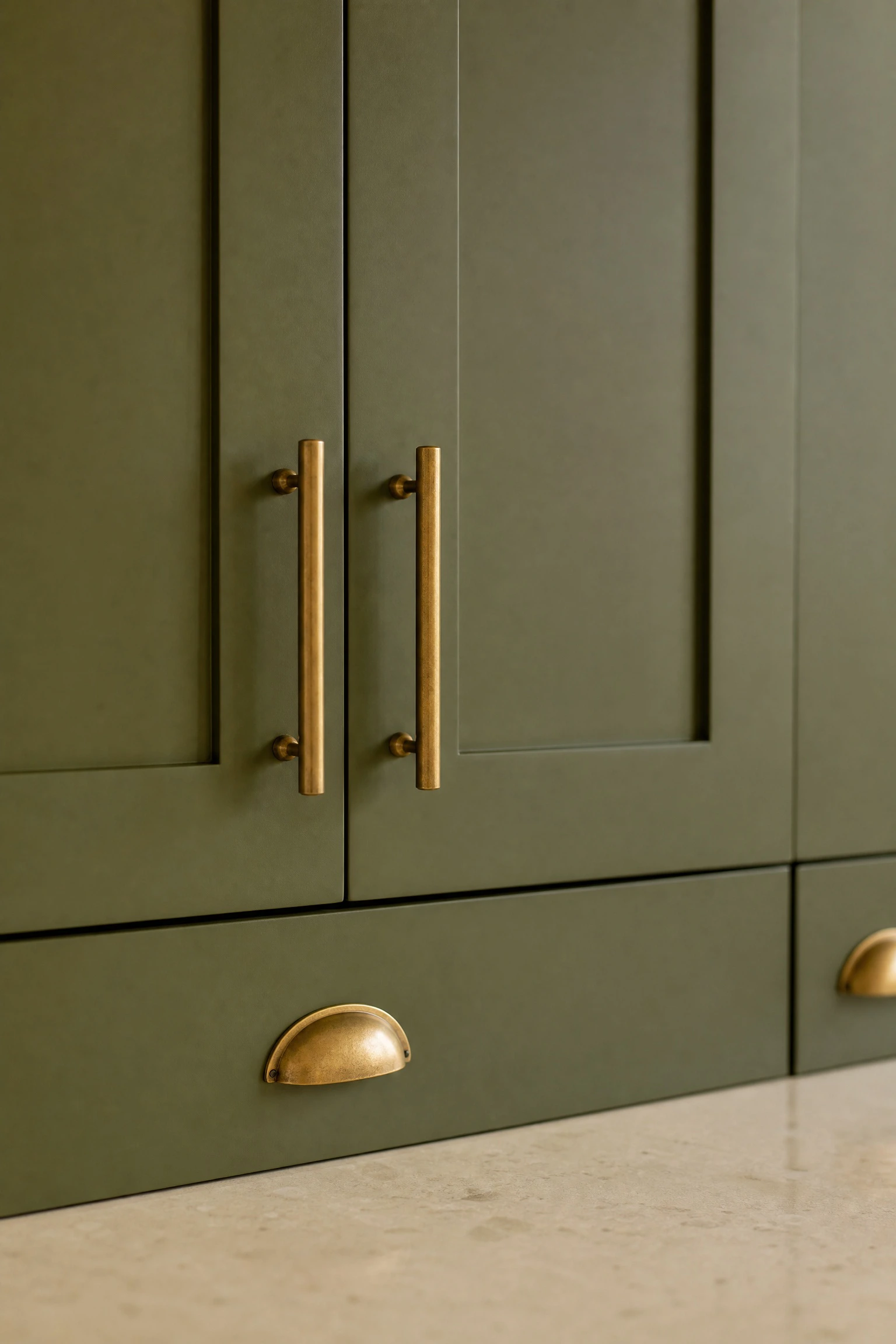 pair avocado green cabinets with brass hardware in a kitchen