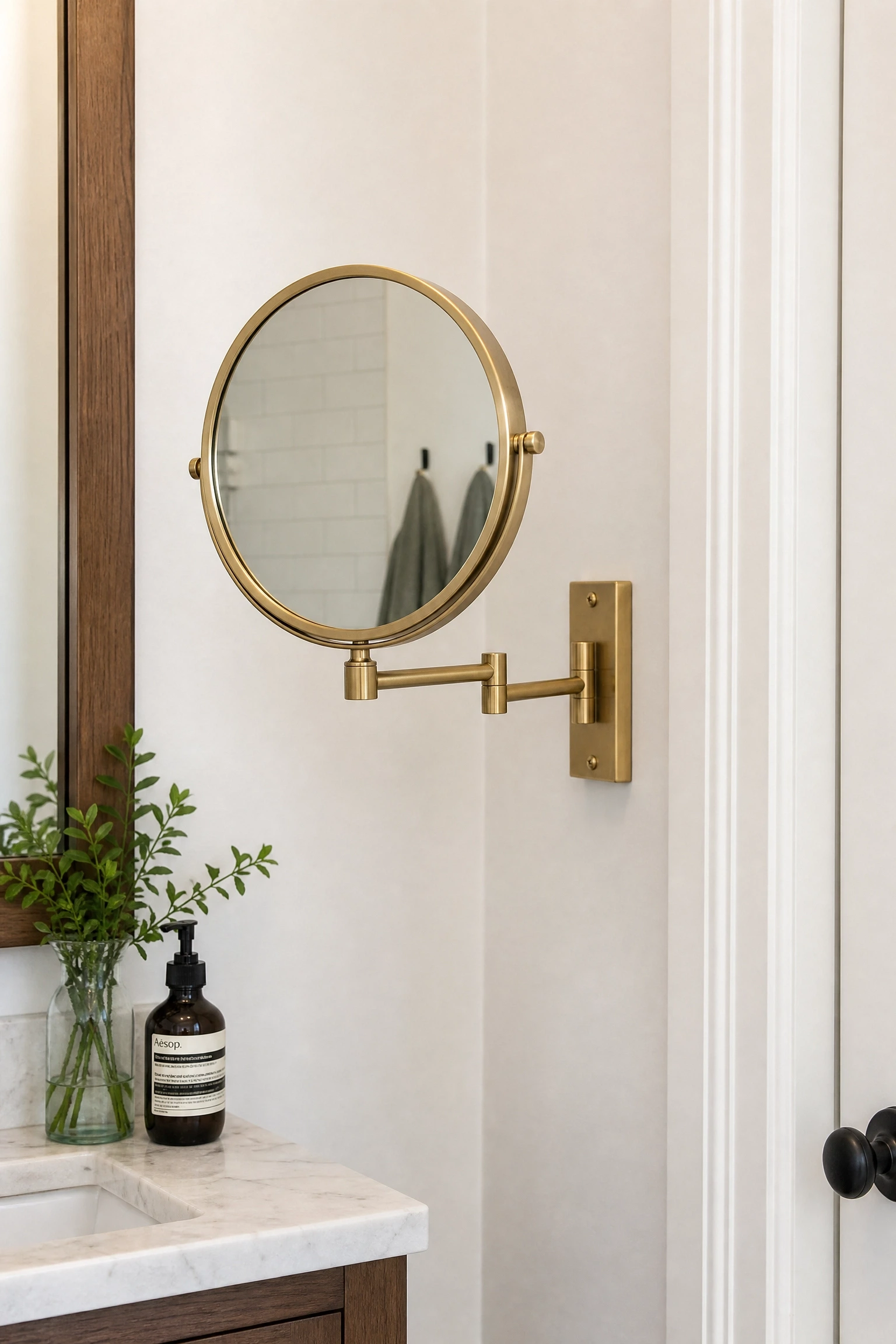 a folding or wall-mounted magnifying mirror in a bathroom