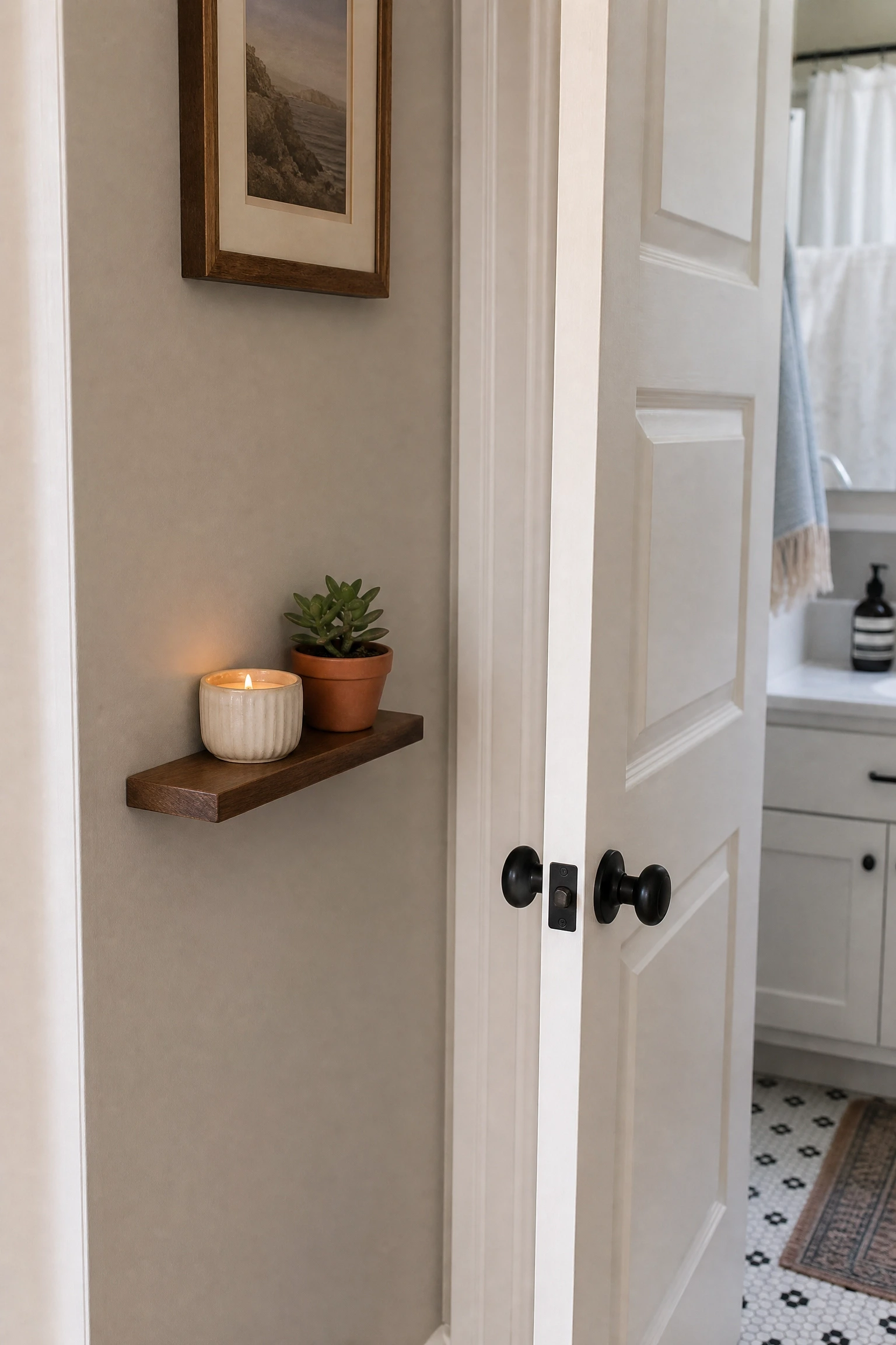 a narrow shelf on the door-frame wall in a bathroom