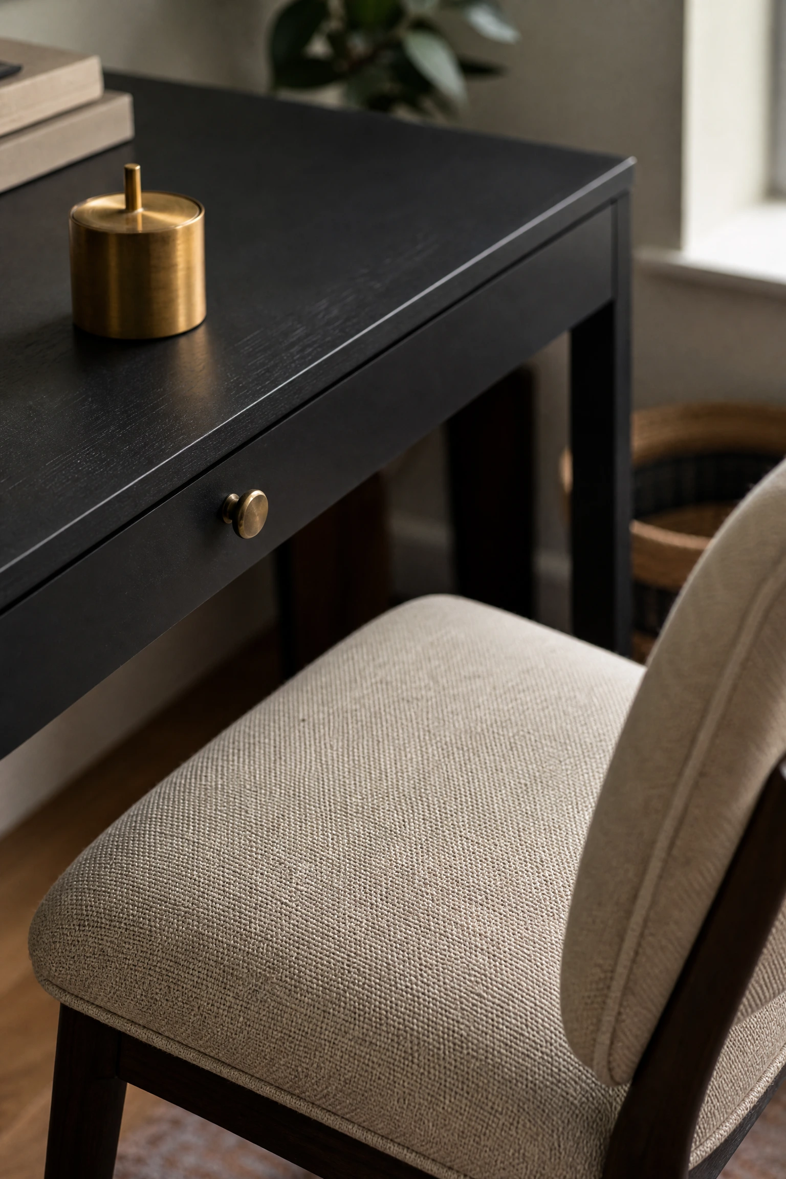 material contrast: warm beige linen against a matte black desk surface in a office