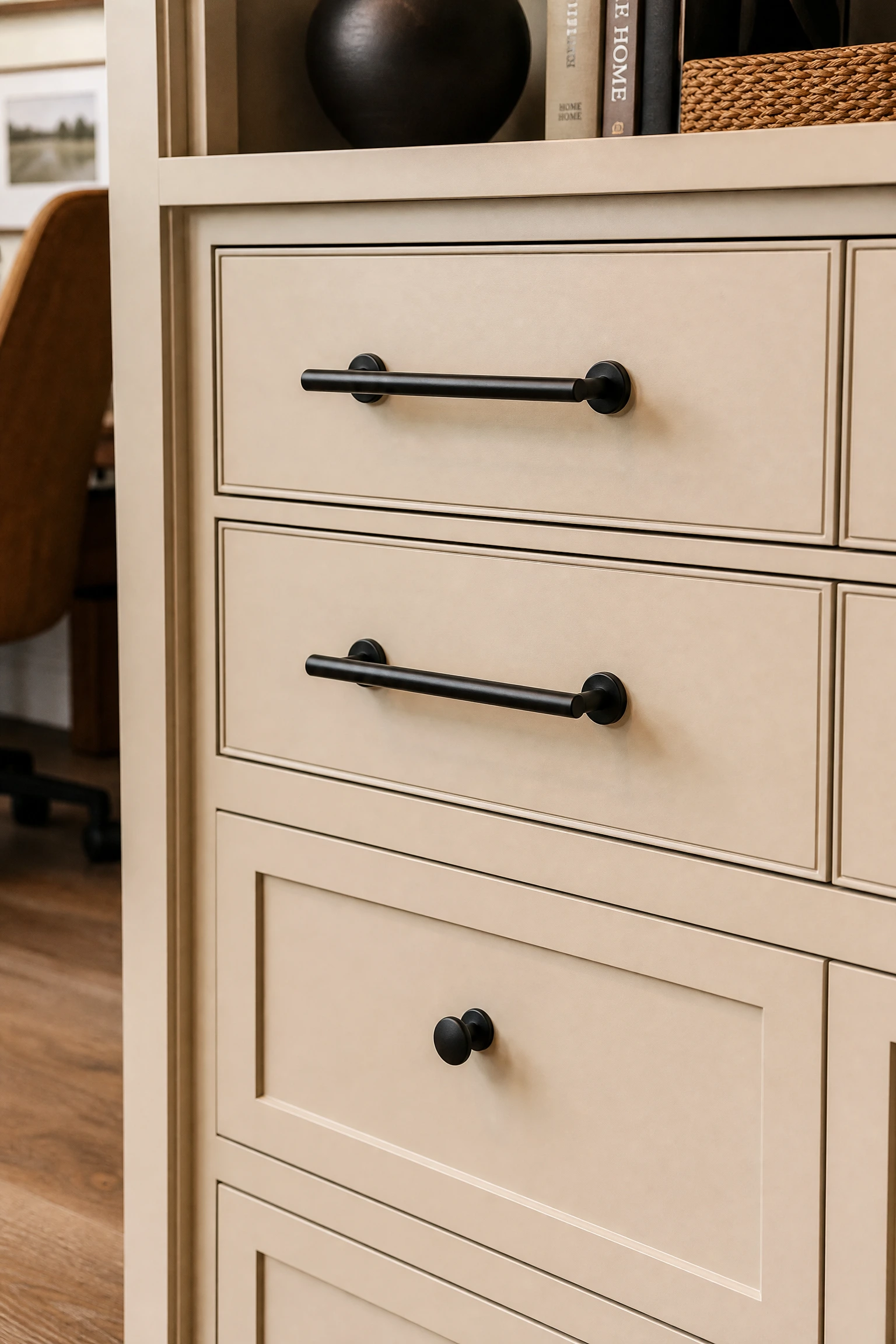 the detail that finishes it: black hardware on beige storage units in a office