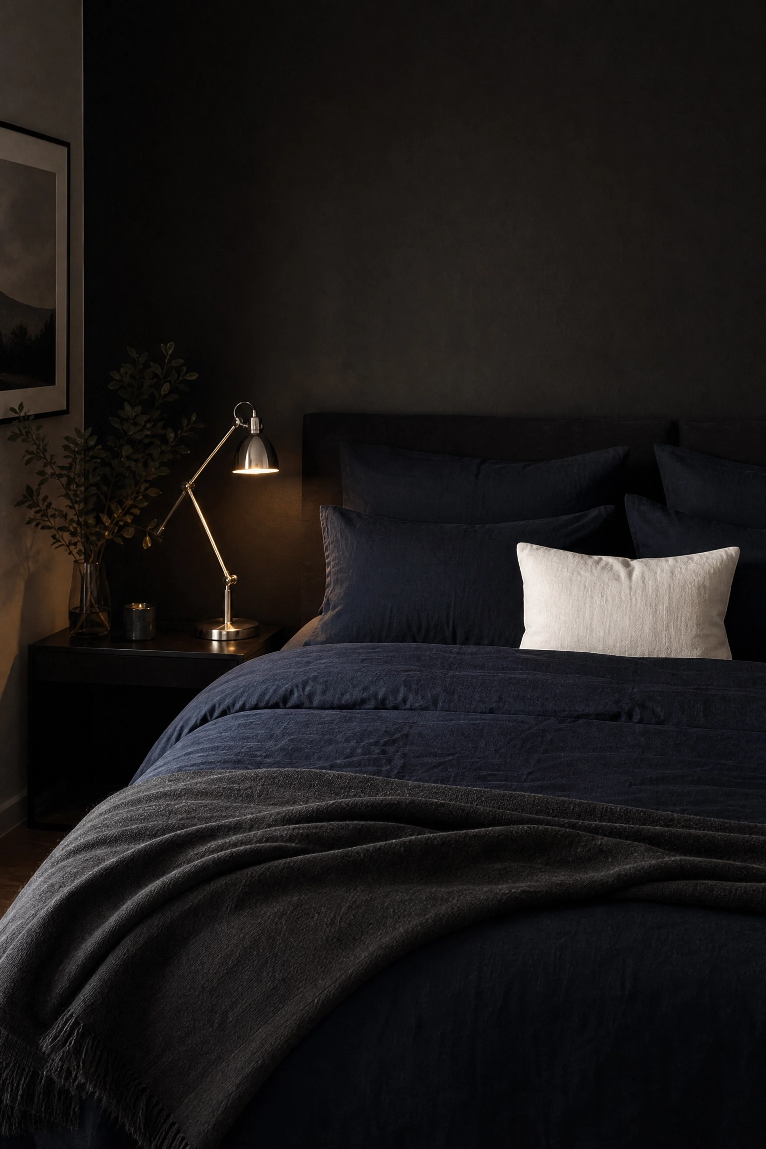black wall paired with navy or inky blue bedding in a bedroom