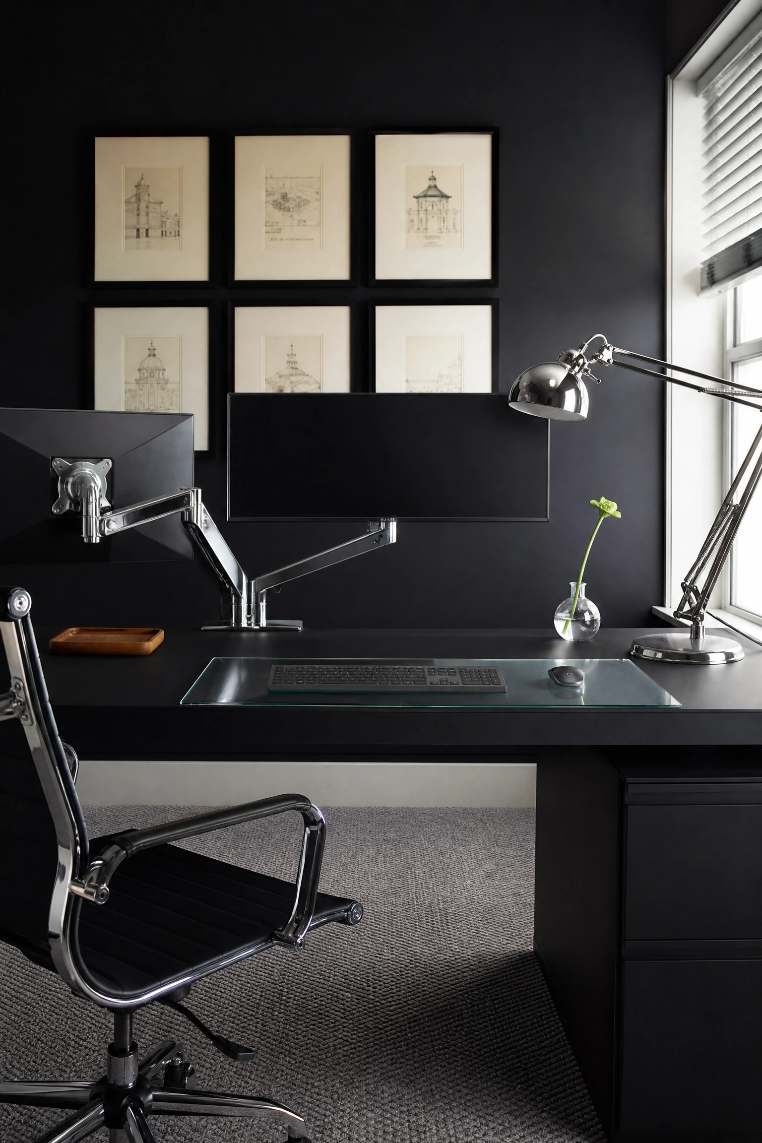 black desk with chrome and glass accents in a office