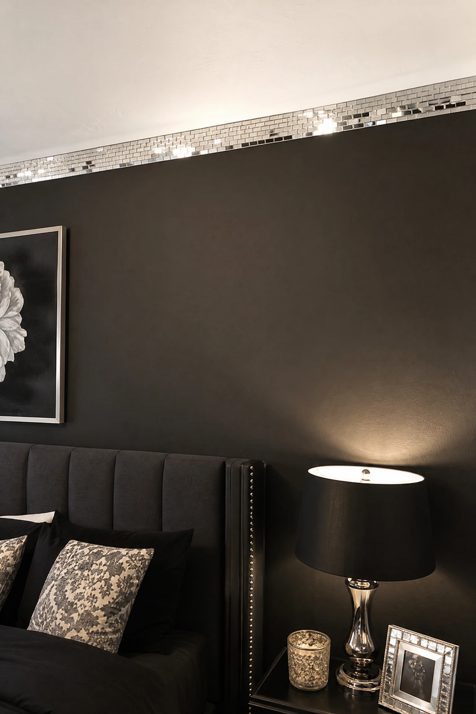 black bedroom with mirrored mosaic tile accent strip
