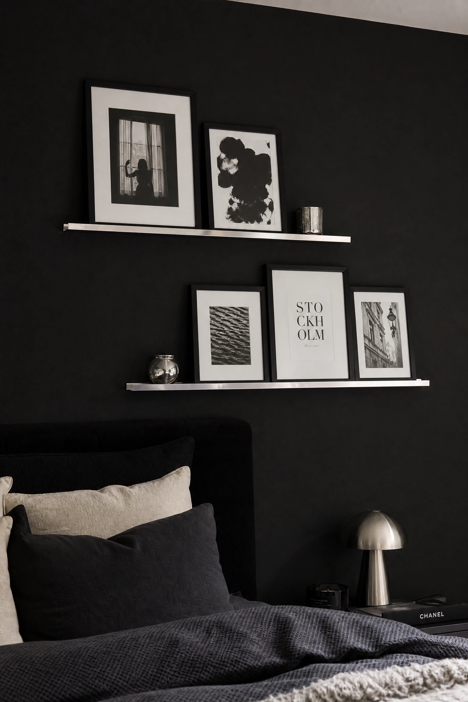 black bedroom with silver picture ledges
