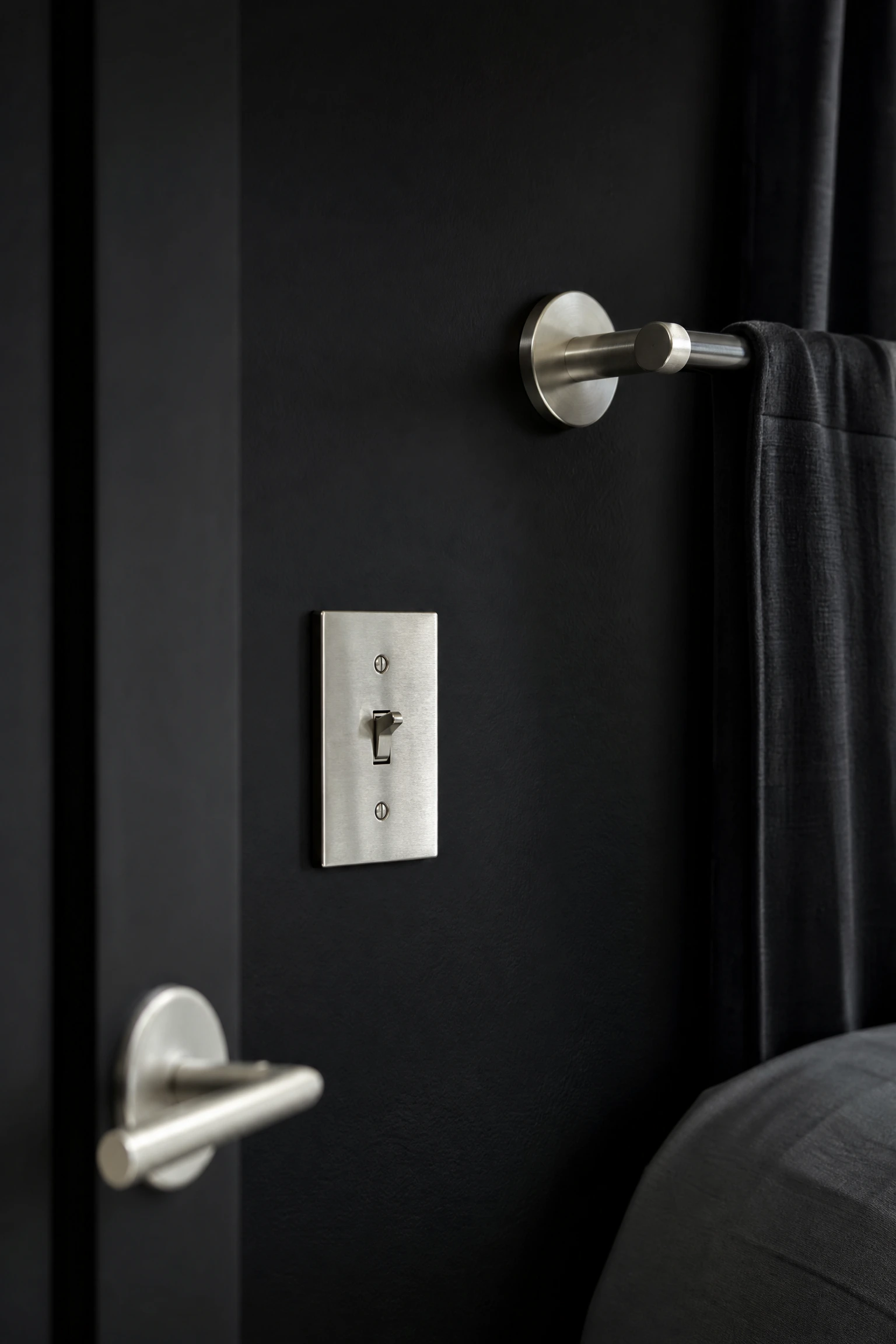 matte black walls with brushed silver hardware in a bedroom