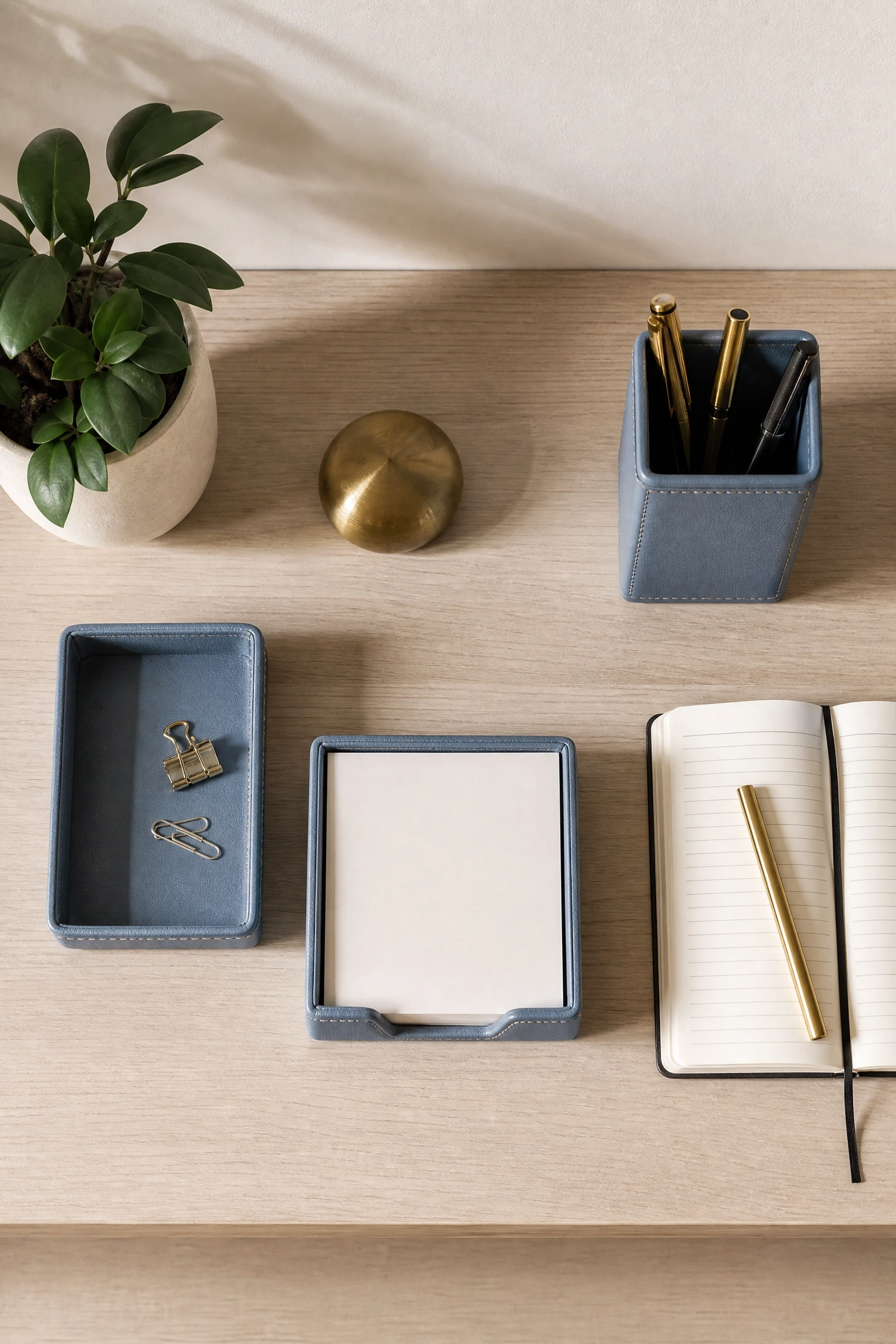 beige desk with blue leather desk accessories in a office