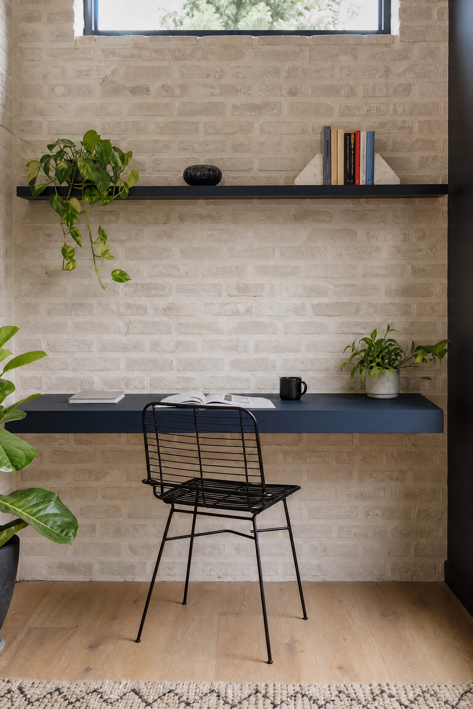 whitewashed beige brick with navy blue floating desk in a office