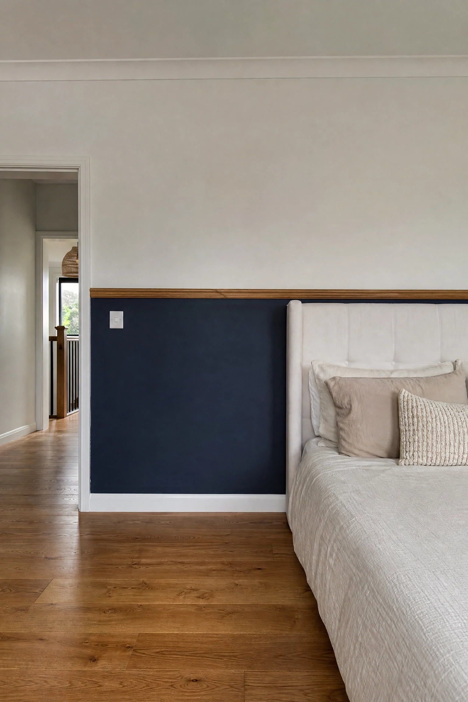 navy blue lower half of walls with wood dado rail in a bedroom