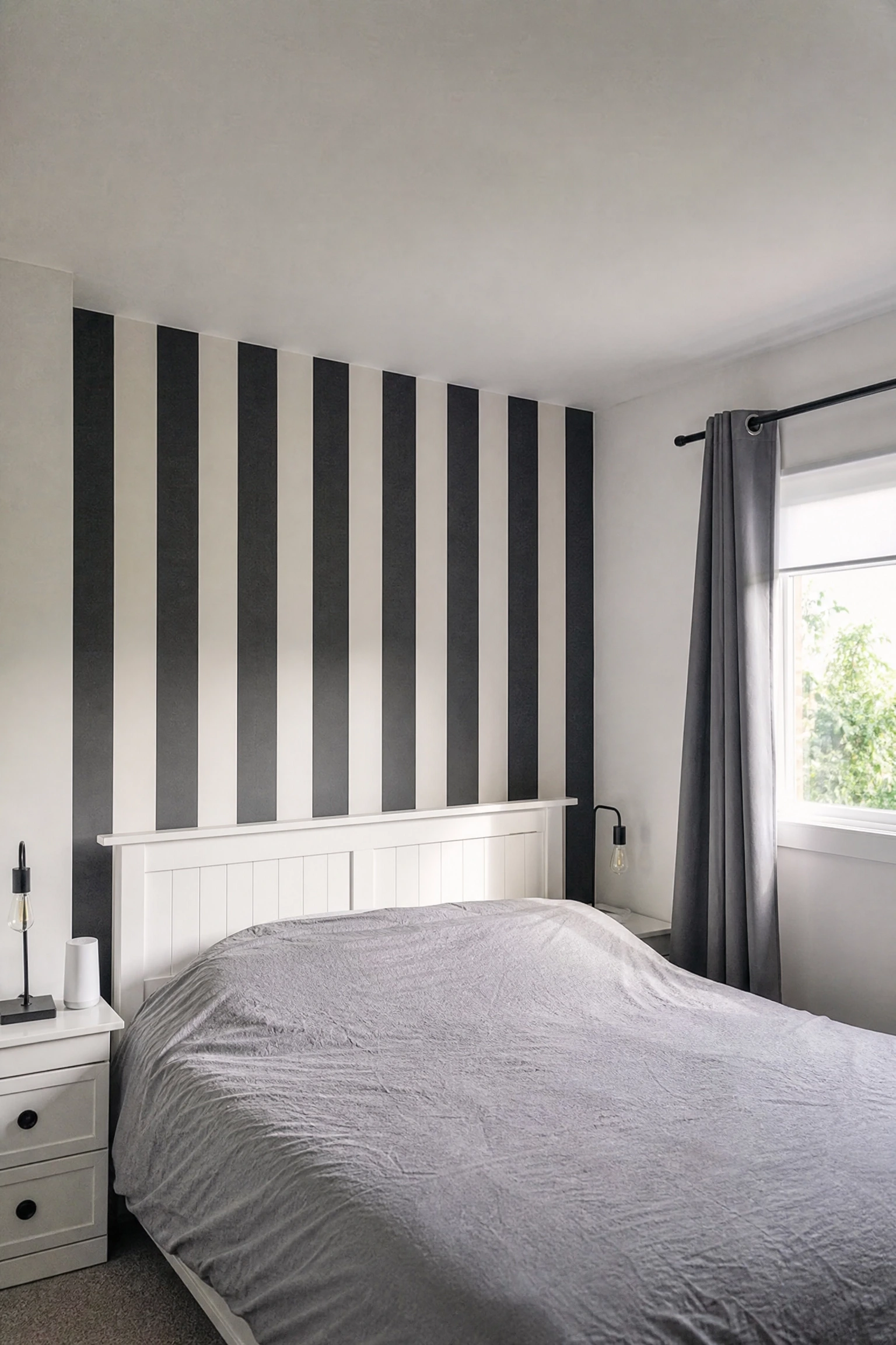 black and white stripe wallpaper for graphic impact in a bedroom