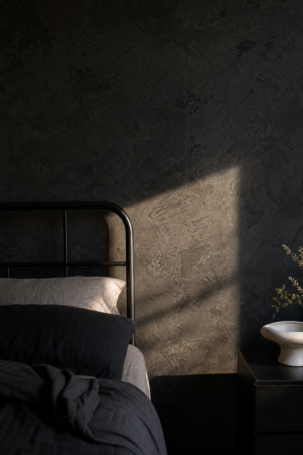 black limewash wall for texture and warmth in a bedroom