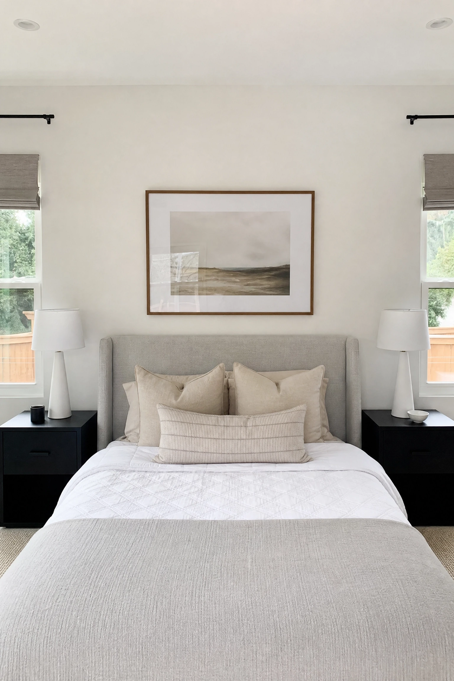 black nightstands against white walls for maximum contrast in a bedroom