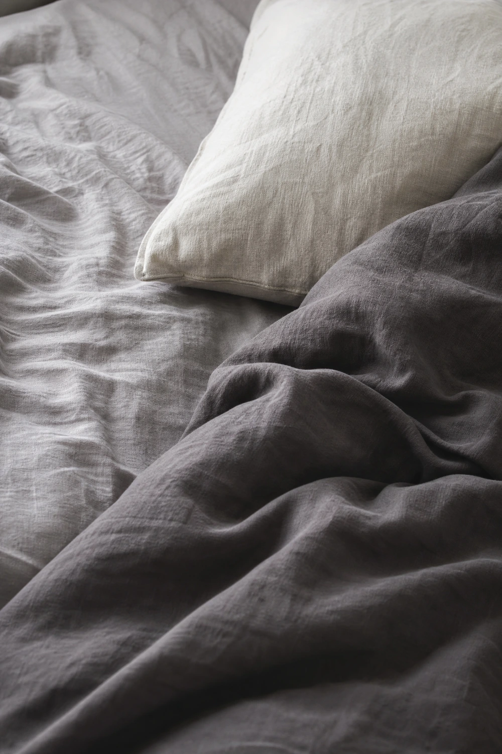 grey linen bedding as the starting point for the whole room in a bedroom