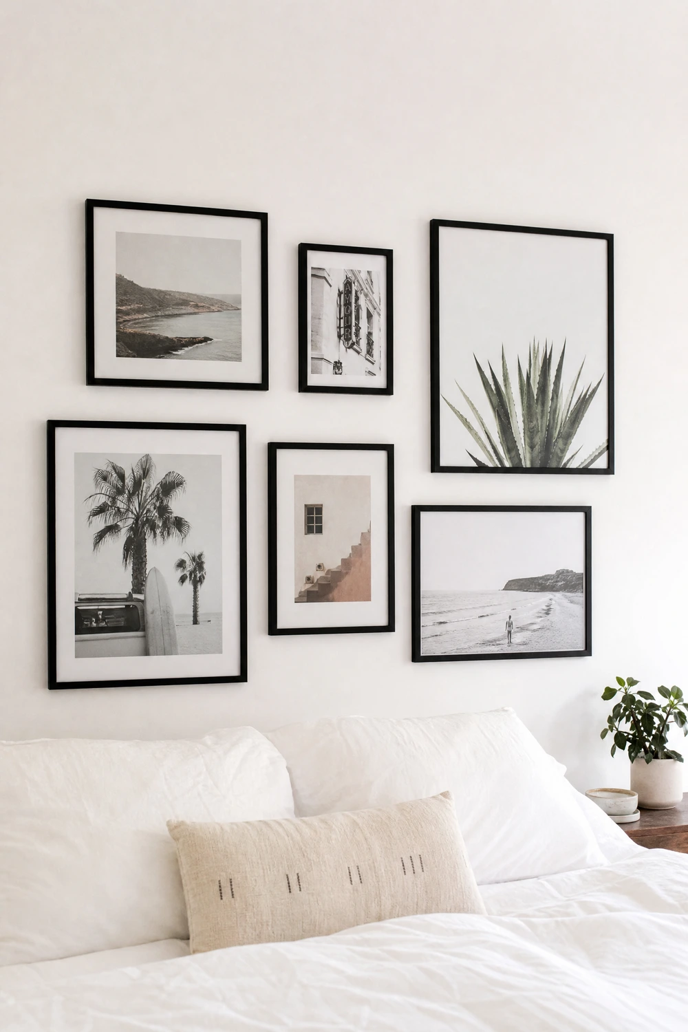 white room with black framed gallery wall in a bedroom