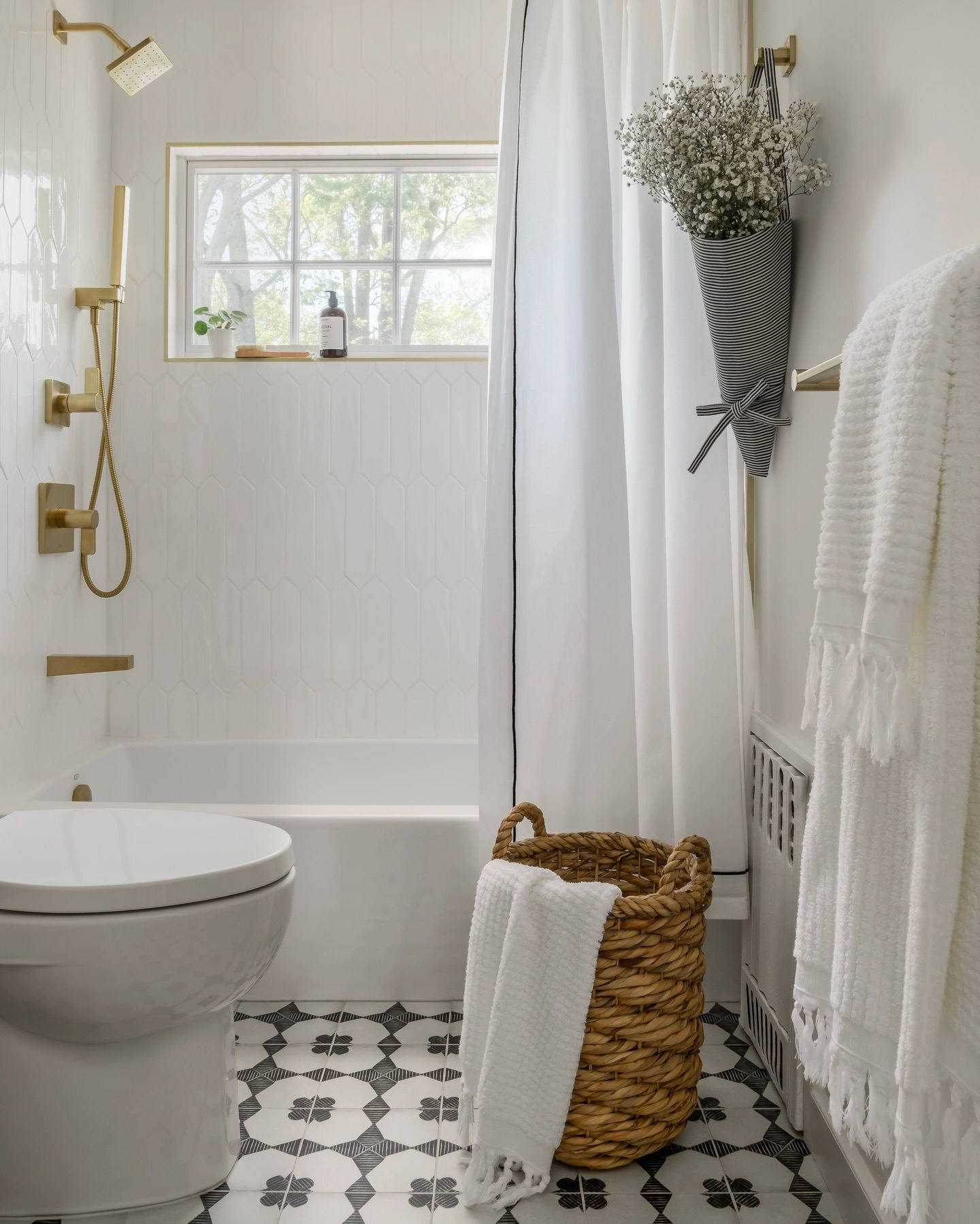 Beige and white bathroom textiles with a woven laundry basket