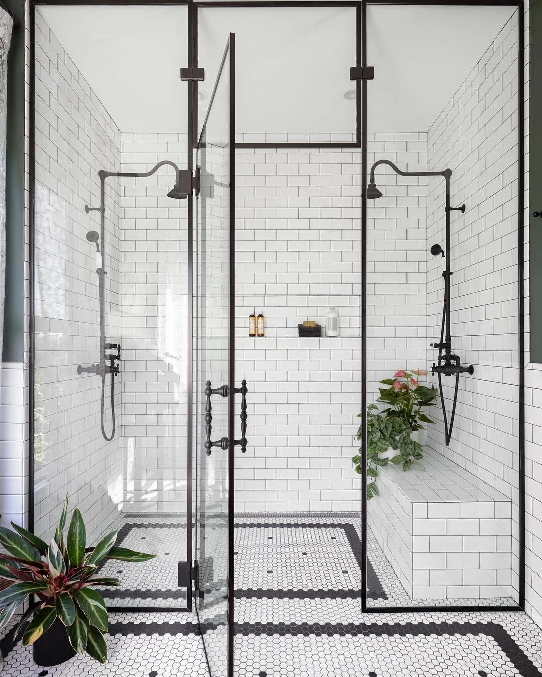 Black-framed shower glass over white subway tiles