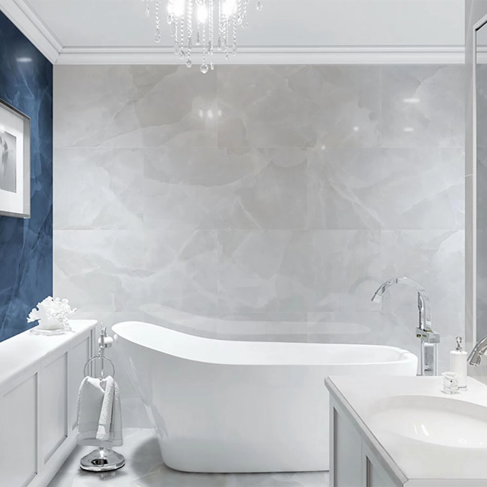 Large format white tiles behind a freestanding bathtub